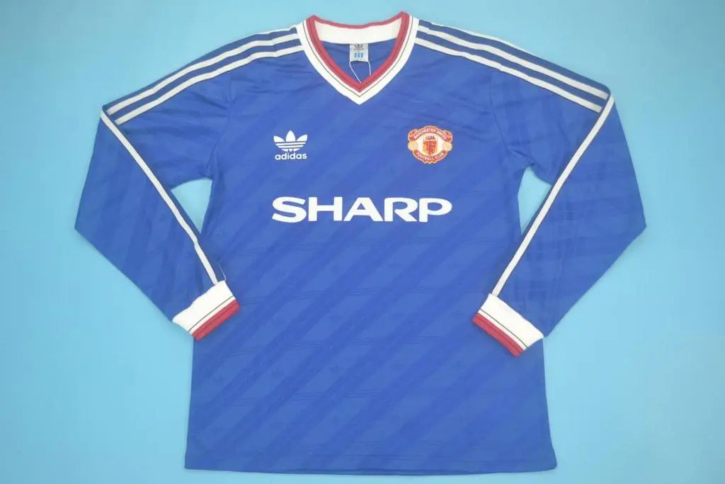 MAILLOT RETRO MANCHESTER UNITED EXTÉRIEUR 1986/1988 VERSION MANCHES LONGUES - Maillot du Monde